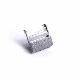 The Kirby 110306 foot pedal is a genuine OEM on/off switch cover pedal used on the Kirby Sentria upright vacuum. It sits at the rear of the transmission housing and provides a durable foot-operated surface for activating and protecting the main power switch assembly.